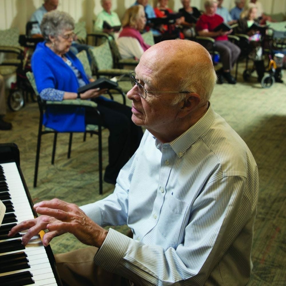 senior man playing piano